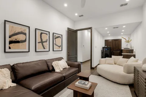 a living room with furniture and a glass door