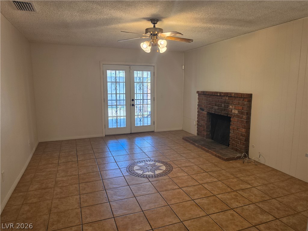 5289 Reeder Circle Las Vegas, NV 89119 - Photo 11 of 40 A classic brick fireplace and decorative tile flooring define this welcoming living area.