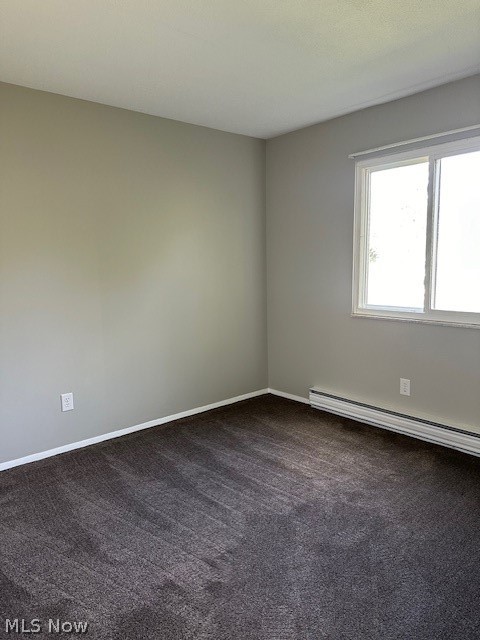 4376 Darrow Road, Unit 7 Stow, OH 44224 - Photo 9 of 23 Unfurnished room featuring carpet flooring and a baseboard heating unit