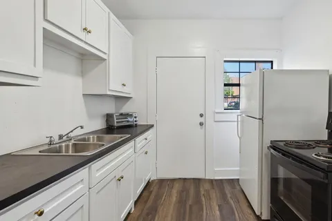 a kitchen with a sink and a refrigerator