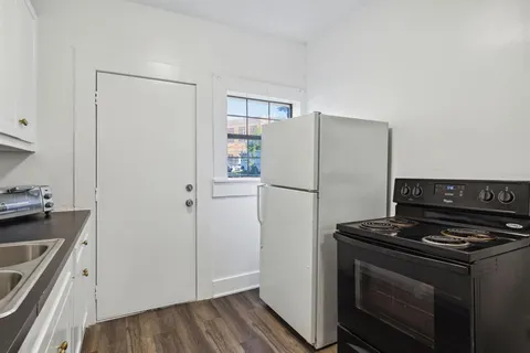a kitchen with granite countertop a stove and a microwave