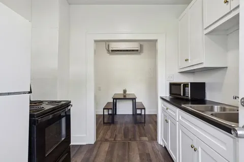 a kitchen with stainless steel appliances a stove microwave and cabinets