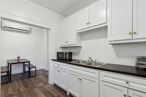 a large bedroom with a bed and a window