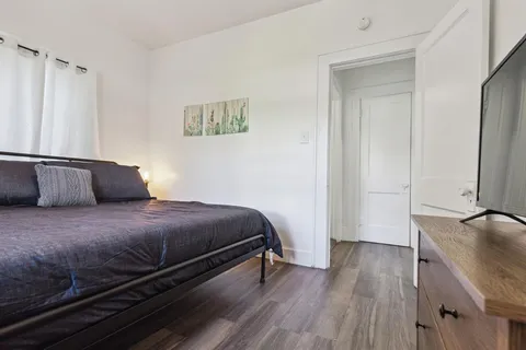 a bedroom with a bed and a flat screen tv