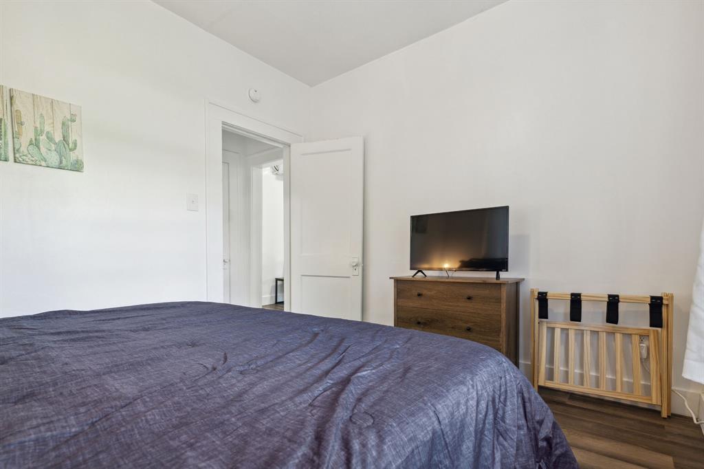 112 West Eighth Street Dallas, TX 75208 - Photo 21 of 34 a bedroom with a bed and a flat screen tv