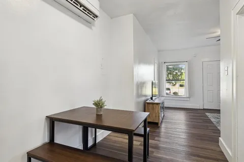 a view of a workspace with furniture and wooden floor