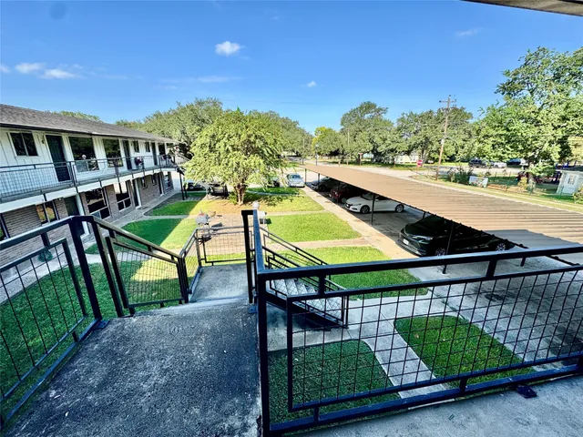 a view of a hallway with furniture and chandelier