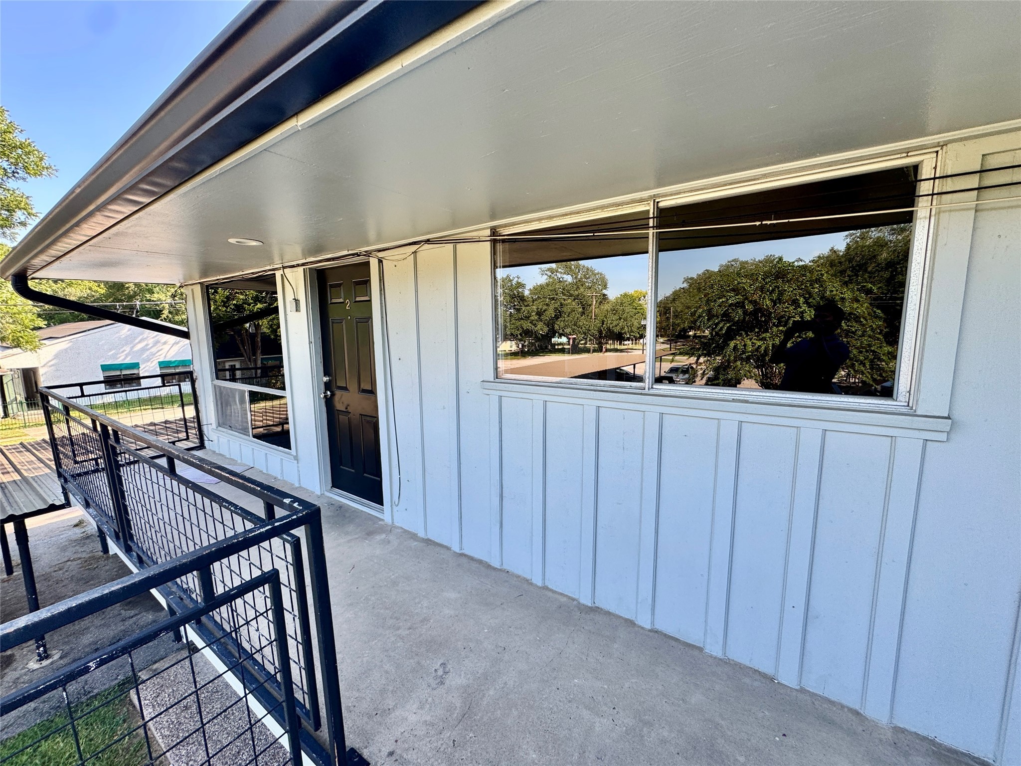 2201 North Grand Boulevard, Unit 2 Pearland, TX 77581 - Photo 3 of 9 a view of a hallway with furniture and chandelier