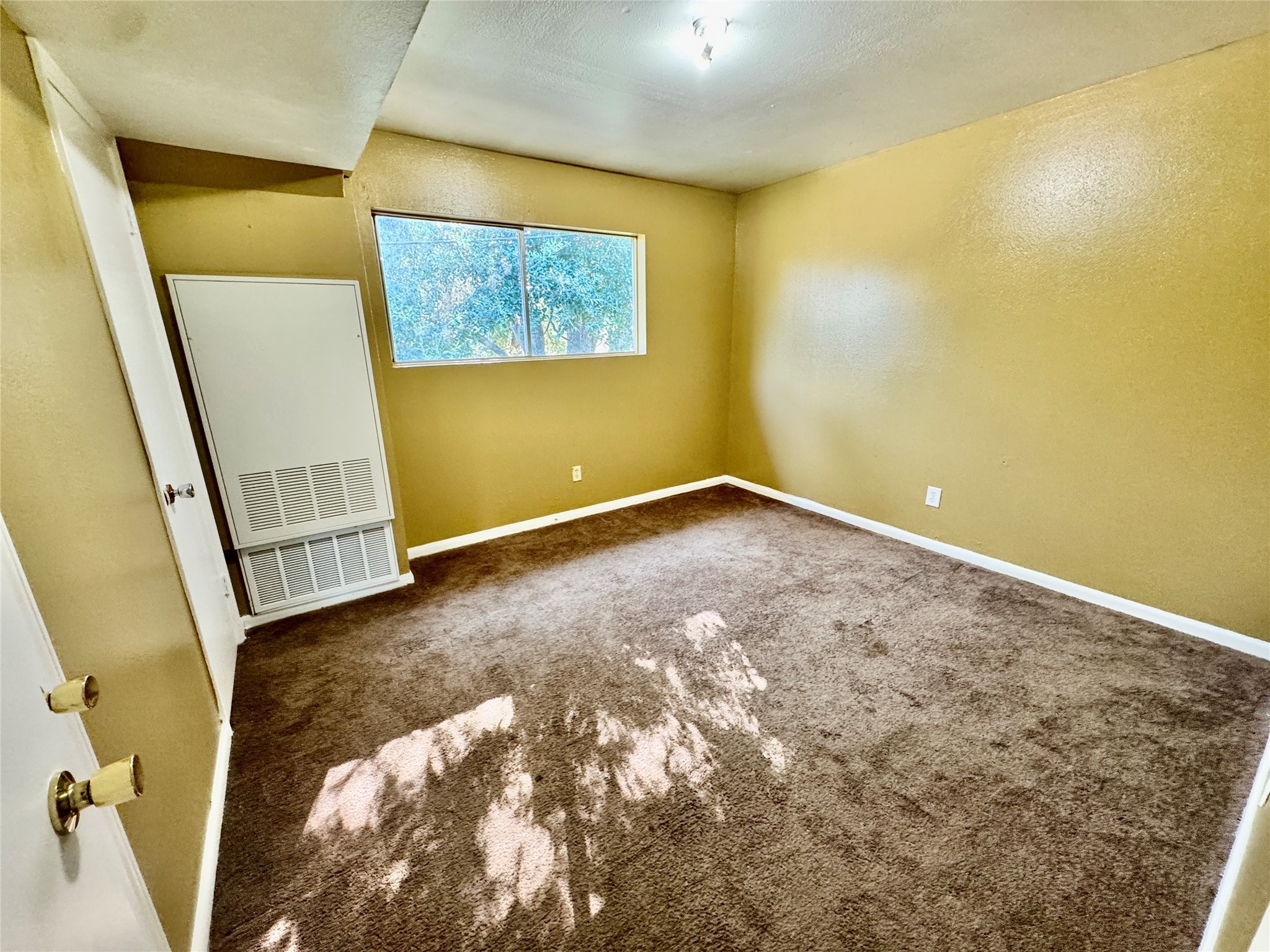 2201 North Grand Boulevard, Unit 2 Pearland, TX 77581 - Photo 4 of 9 a view of an empty room with a window