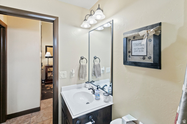 210 Talon Court Ivins, UT 84738 - Photo 24 of 60 Half bath with vanity and a textured wall