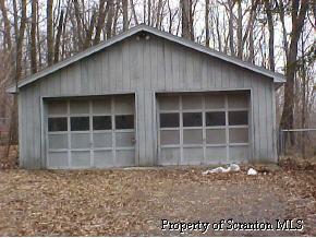1 Sand Spring Road Cresco, PA 18326 - Photo 2 of 3 a front view of a house with a yard