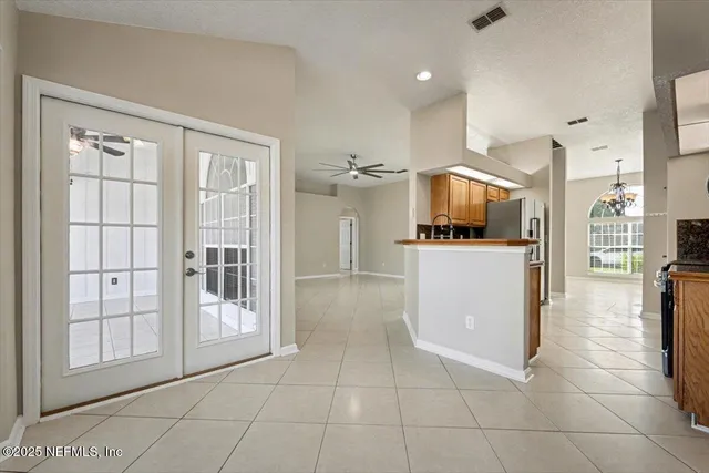 a kitchen with stainless steel appliances granite countertop a refrigerator and a stove top oven