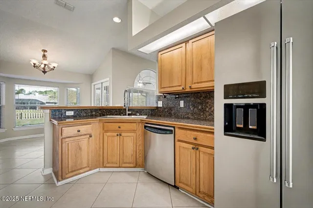 a view of empty room with wooden floor and window