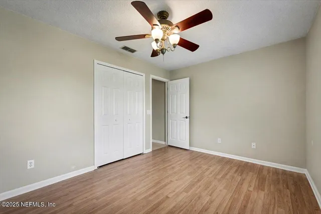 a view of a livingroom with a ceiling fan and window