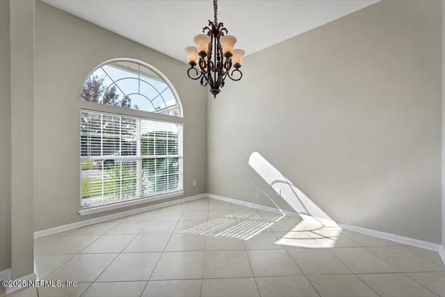 a view of an empty room with a fireplace and a window
