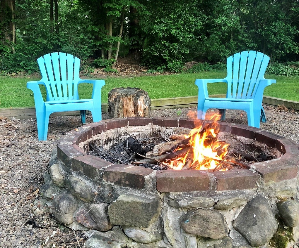 5038 Exeter Road Erie, PA 16509 - Photo 31 of 35 NIGHTTIME FUN WITH THE FIRE PIT AND A TREED BACKDROP