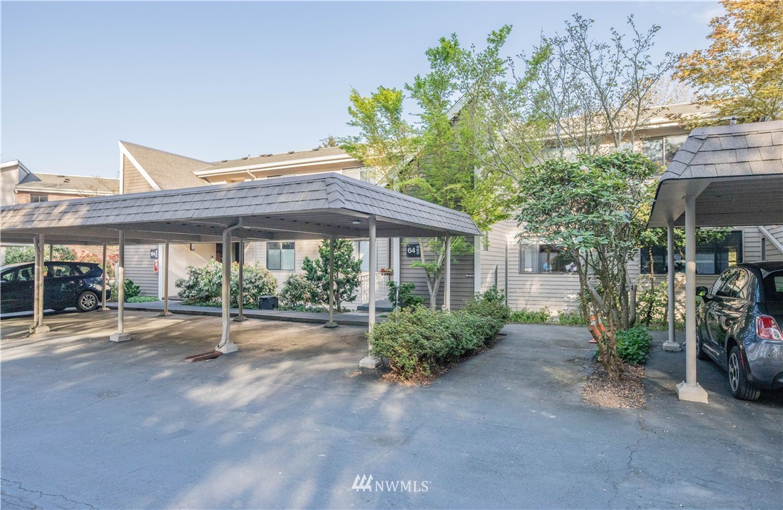 6413 Sand Point Way Northeast Seattle, WA 98115 - Photo 1 of 25 a patio with a table and chairs under an umbrella
