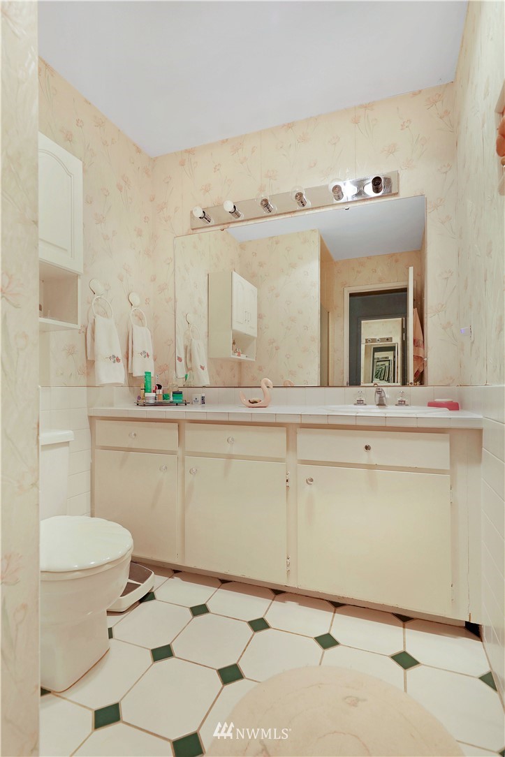 6413 Sand Point Way Northeast Seattle, WA 98115 - Photo 11 of 25 a bathroom with a sink mirror and toilet