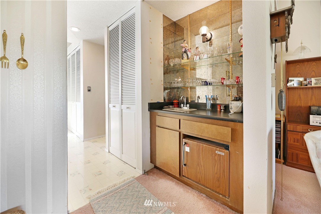 6413 Sand Point Way Northeast Seattle, WA 98115 - Photo 19 of 25 a bathroom with a sink a mirror and a shower