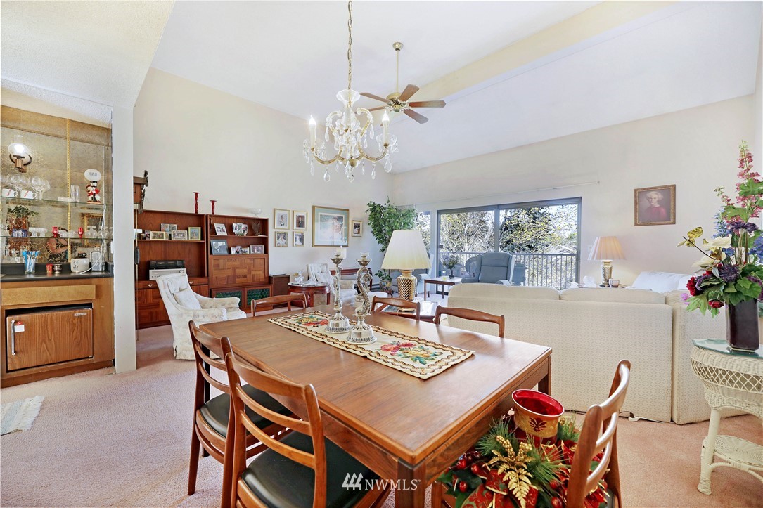6413 Sand Point Way Northeast Seattle, WA 98115 - Photo 21 of 25 a view of a dining room with furniture and a chandelier