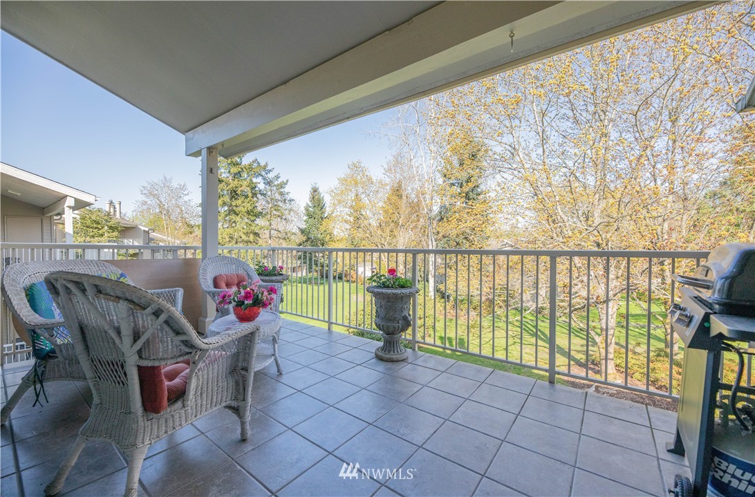 6413 Sand Point Way Northeast Seattle, WA 98115 - Photo 23 of 25 a living room with furniture and a floor to ceiling window