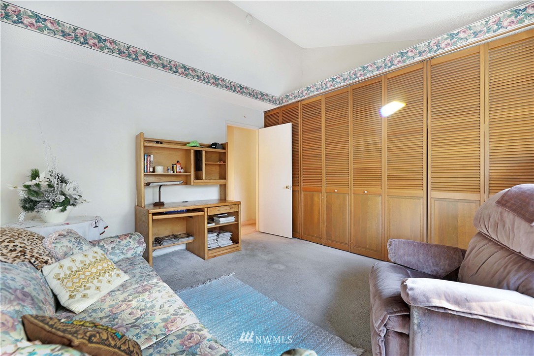 6413 Sand Point Way Northeast Seattle, WA 98115 - Photo 6 of 25 a living room with furniture and a flat screen tv