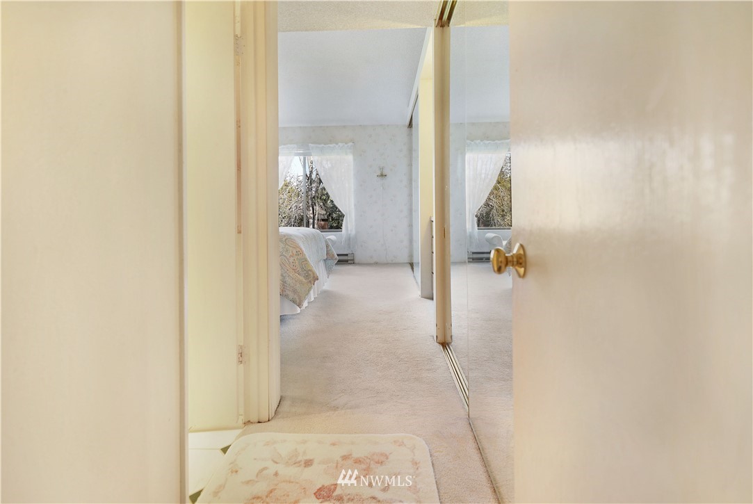6413 Sand Point Way Northeast Seattle, WA 98115 - Photo 9 of 25 a bathroom with a sink and mirror