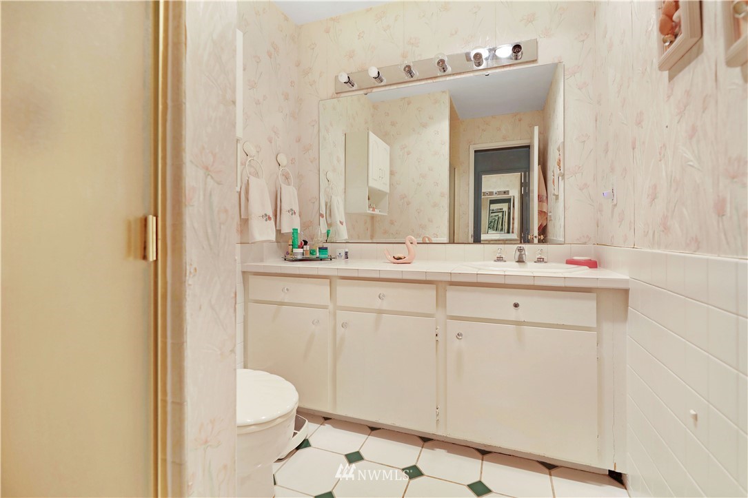 6413 Sand Point Way Northeast Seattle, WA 98115 - Photo 10 of 25 a bathroom with a sink and a mirror