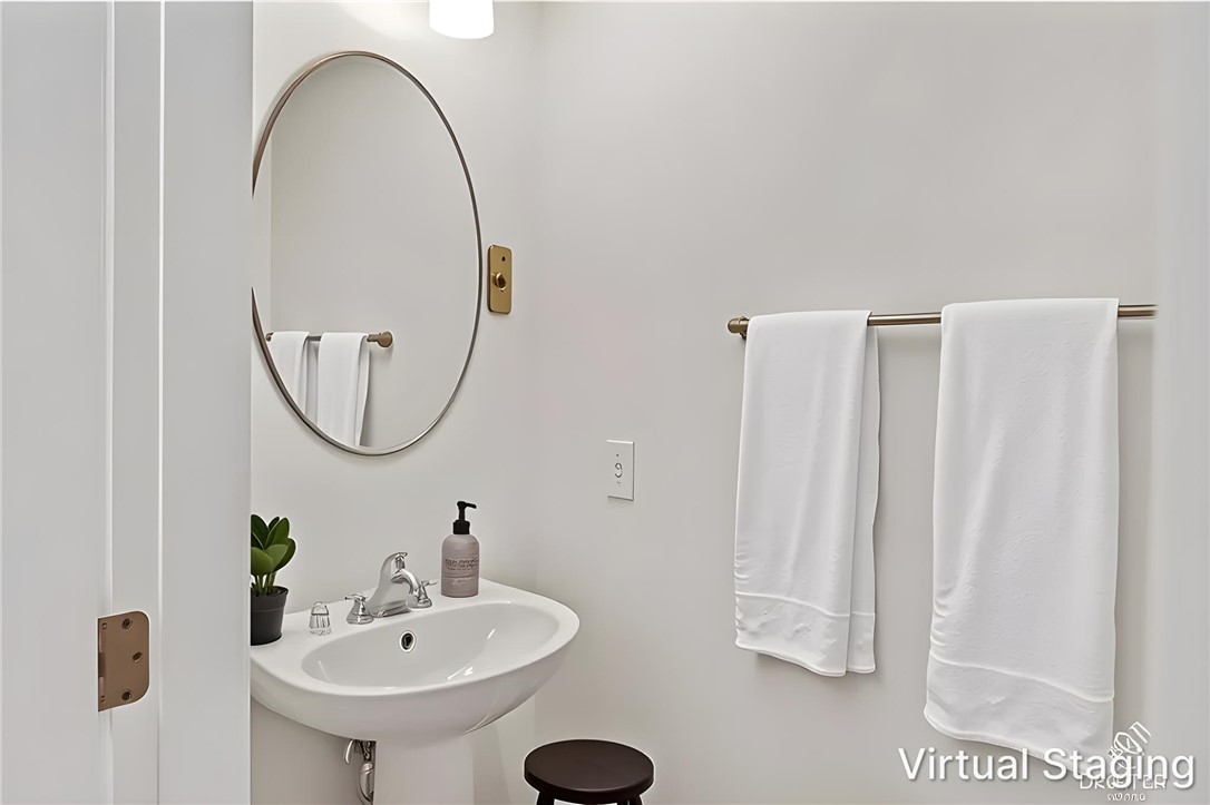 137 Nicklaus Drive Anderson, SC 29621 - Photo 15 of 37 A well-lit powder room offers contemporary fixtures and elegant wall decor.