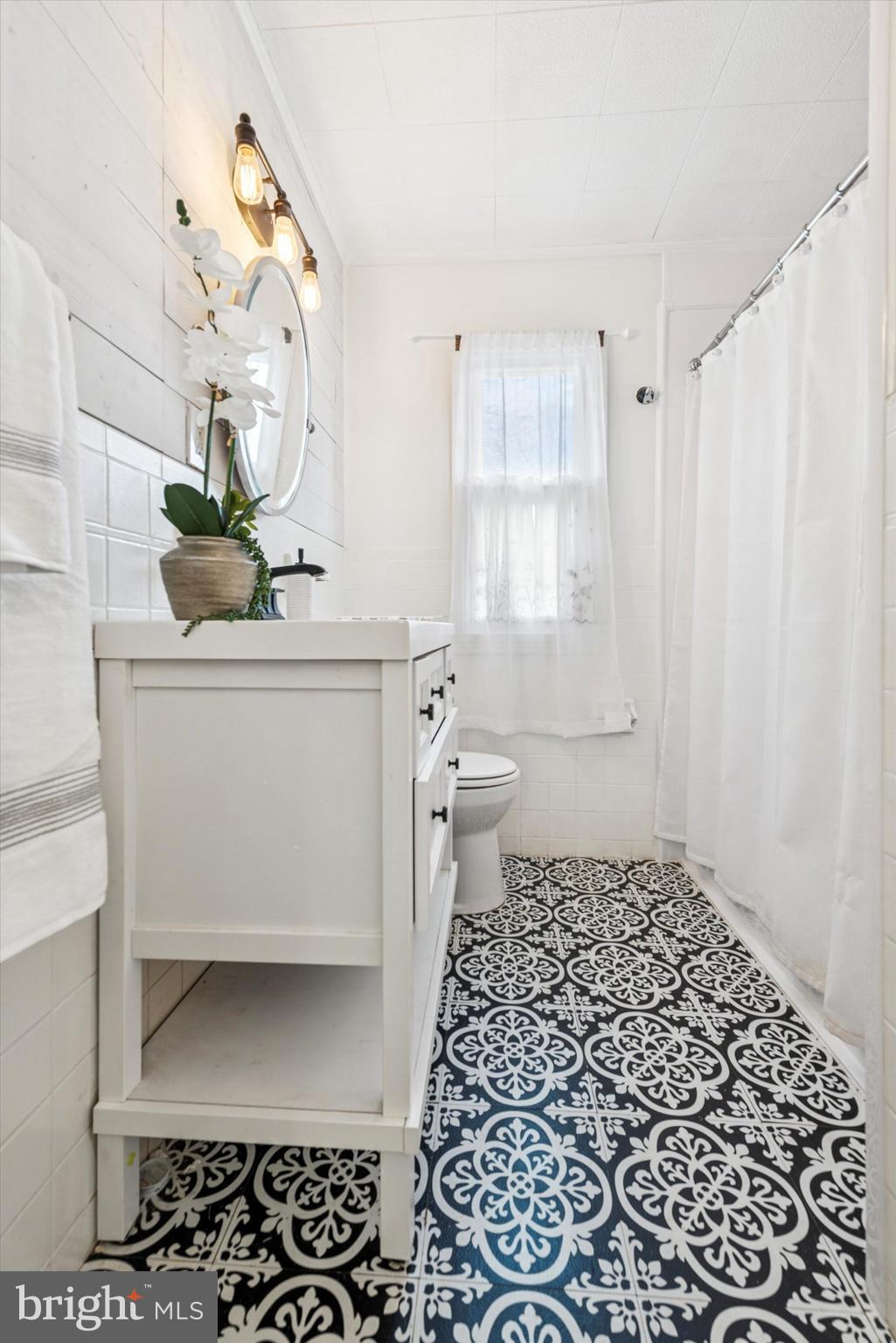 104 Lynbrook Road Paoli, PA 19301 - Photo 13 of 31 a bathroom with a sink a toilet and a mirror