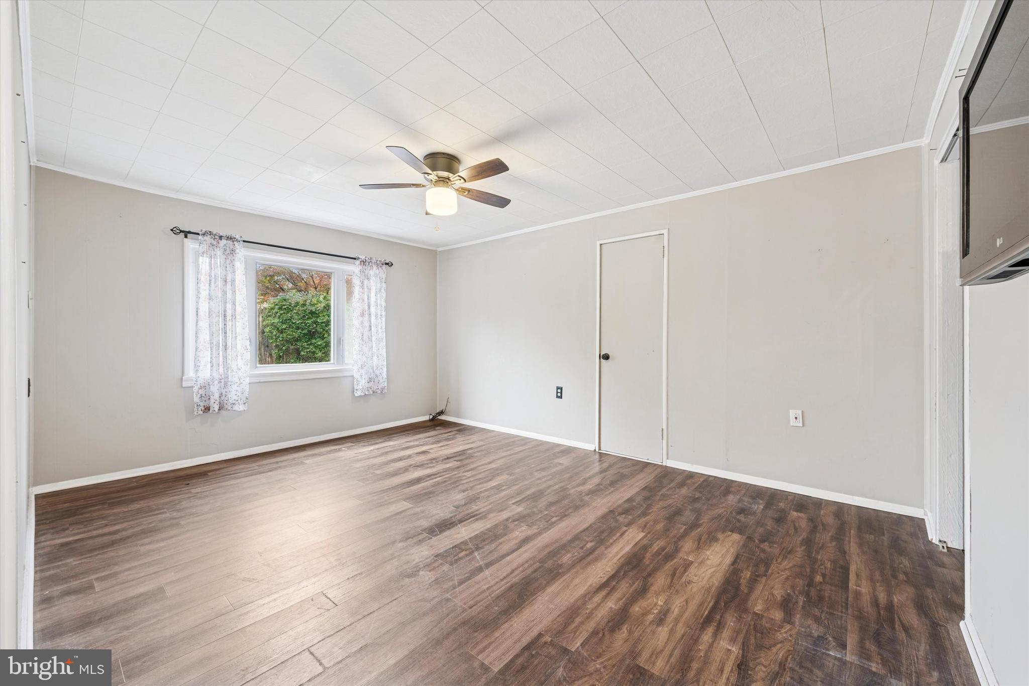 104 Lynbrook Road Paoli, PA 19301 - Photo 21 of 31 a view of an empty room with a window and wooden floor