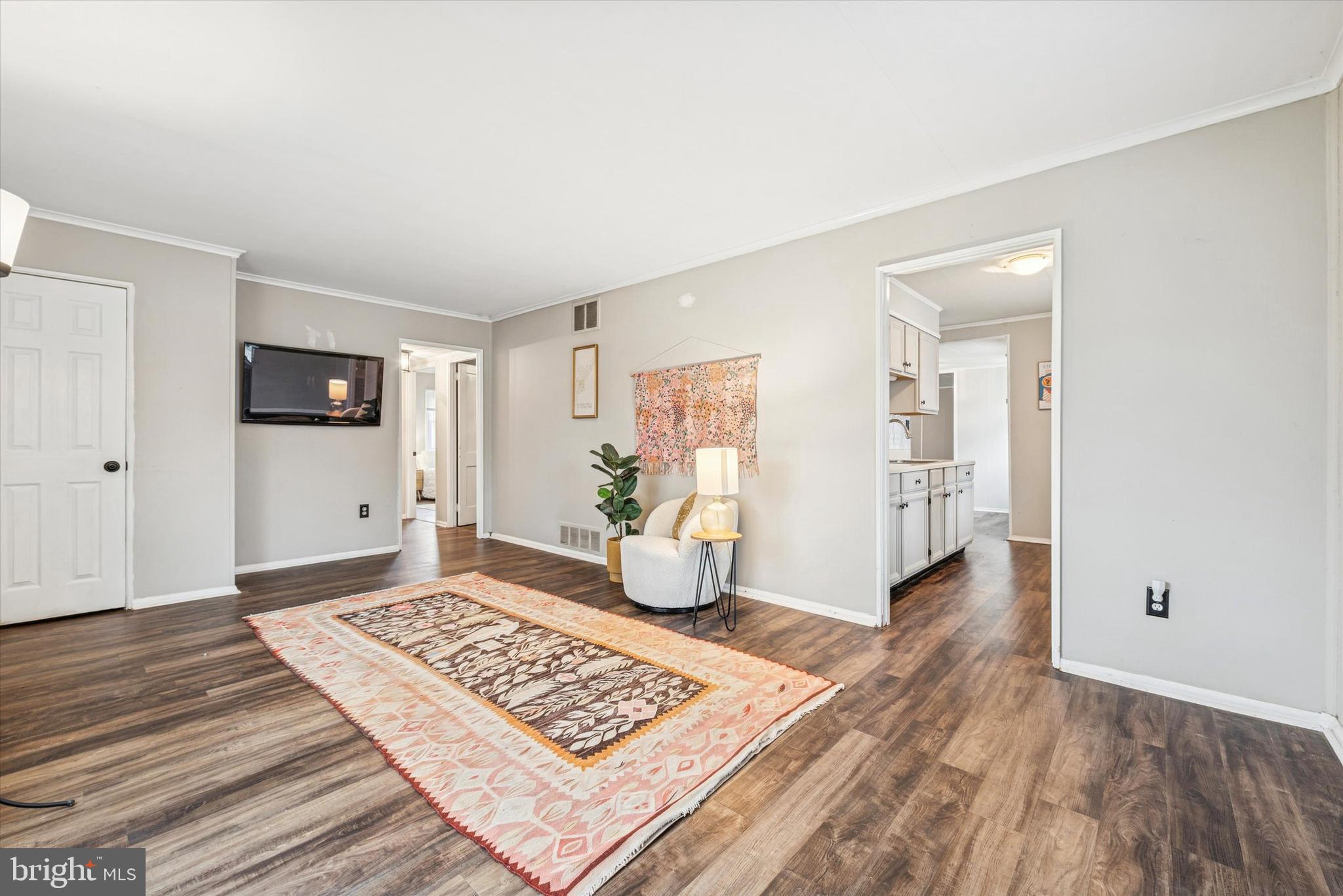 104 Lynbrook Road Paoli, PA 19301 - Photo 5 of 31 a view of an empty room and bedroom with wooden floor