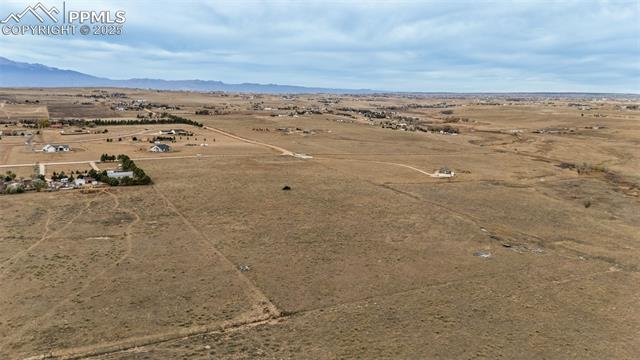 Kennedy Road Peyton, CO 80831 - Photo 3 of 7 Overview of rural landscape featuring a mountain backdrop and a desert landscape