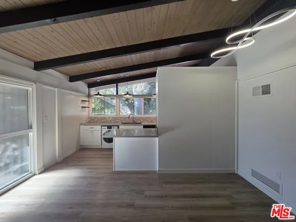a room with wooden floor and window