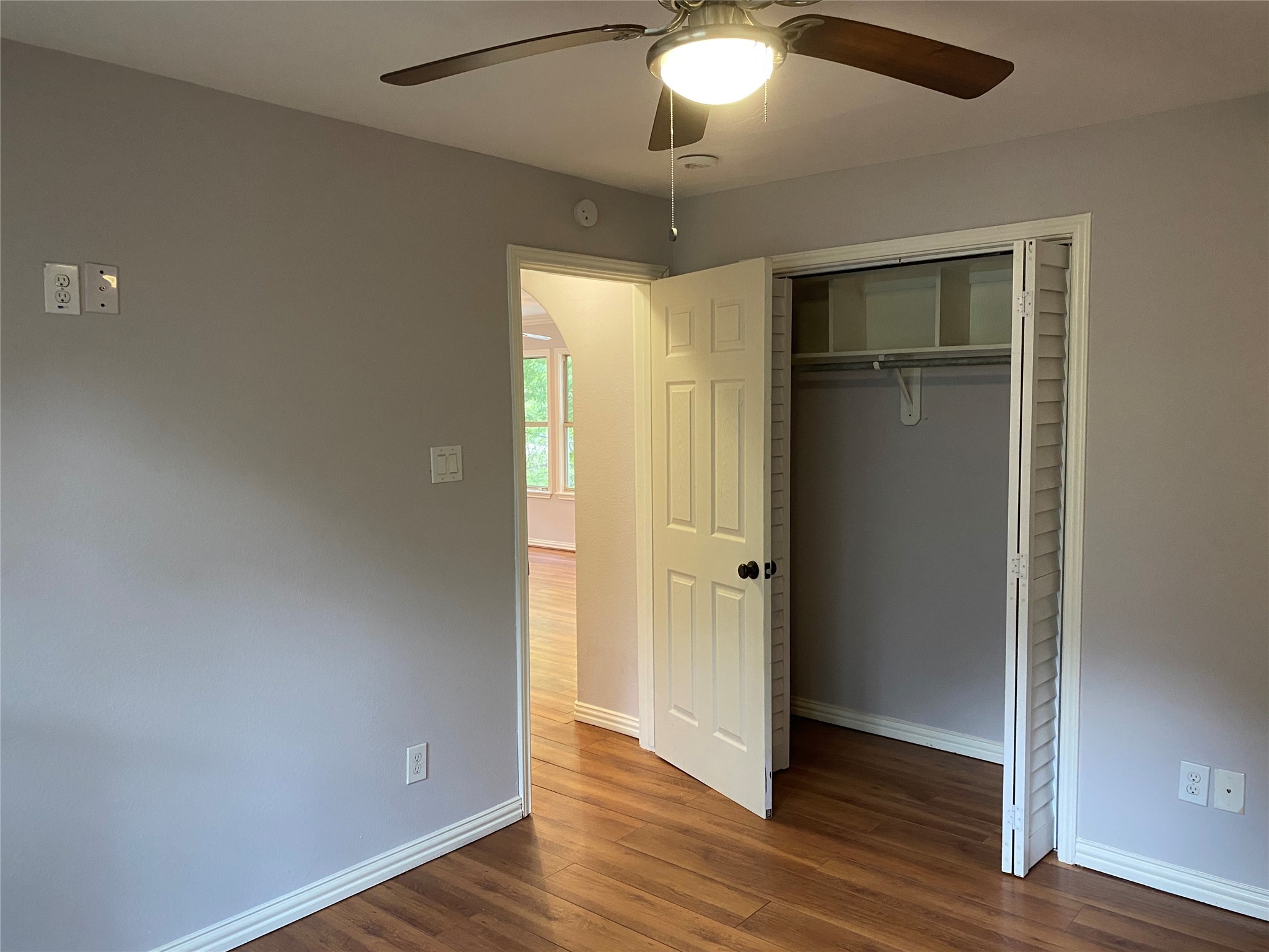 819 Eubanks Street Houston, TX 77022 - Photo 13 of 15 an empty room with wooden floor and a ceiling fan