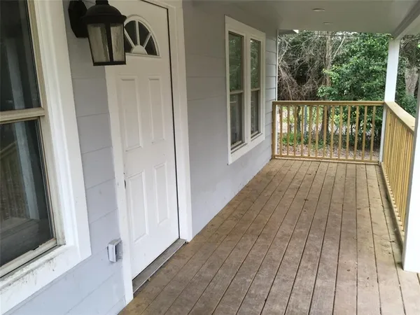 a view of balcony with wooden floor