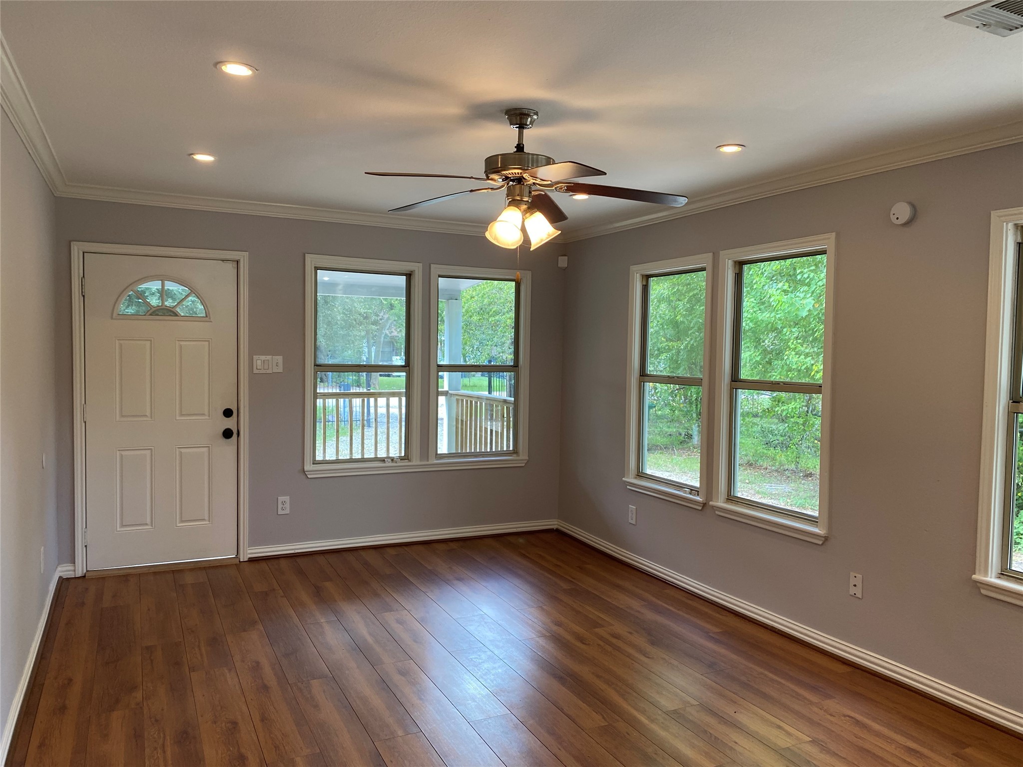 819 Eubanks Street Houston, TX 77022 - Photo 5 of 15 a view of an empty room with wooden floor and a window
