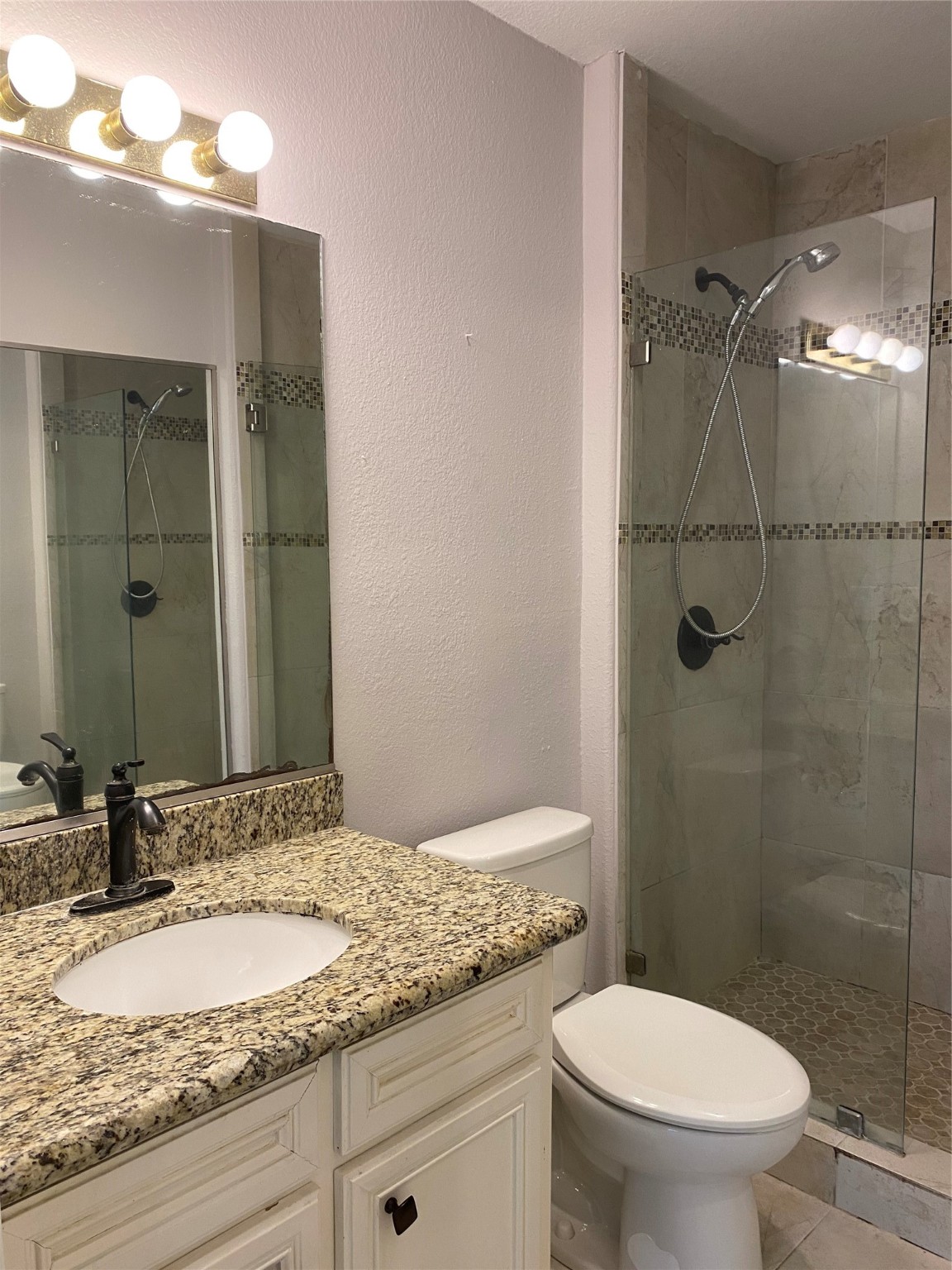 819 Eubanks Street Houston, TX 77022 - Photo 8 of 15 a bathroom with a granite countertop sink toilet and shower