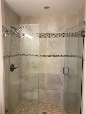 a bathroom with a glass shower door