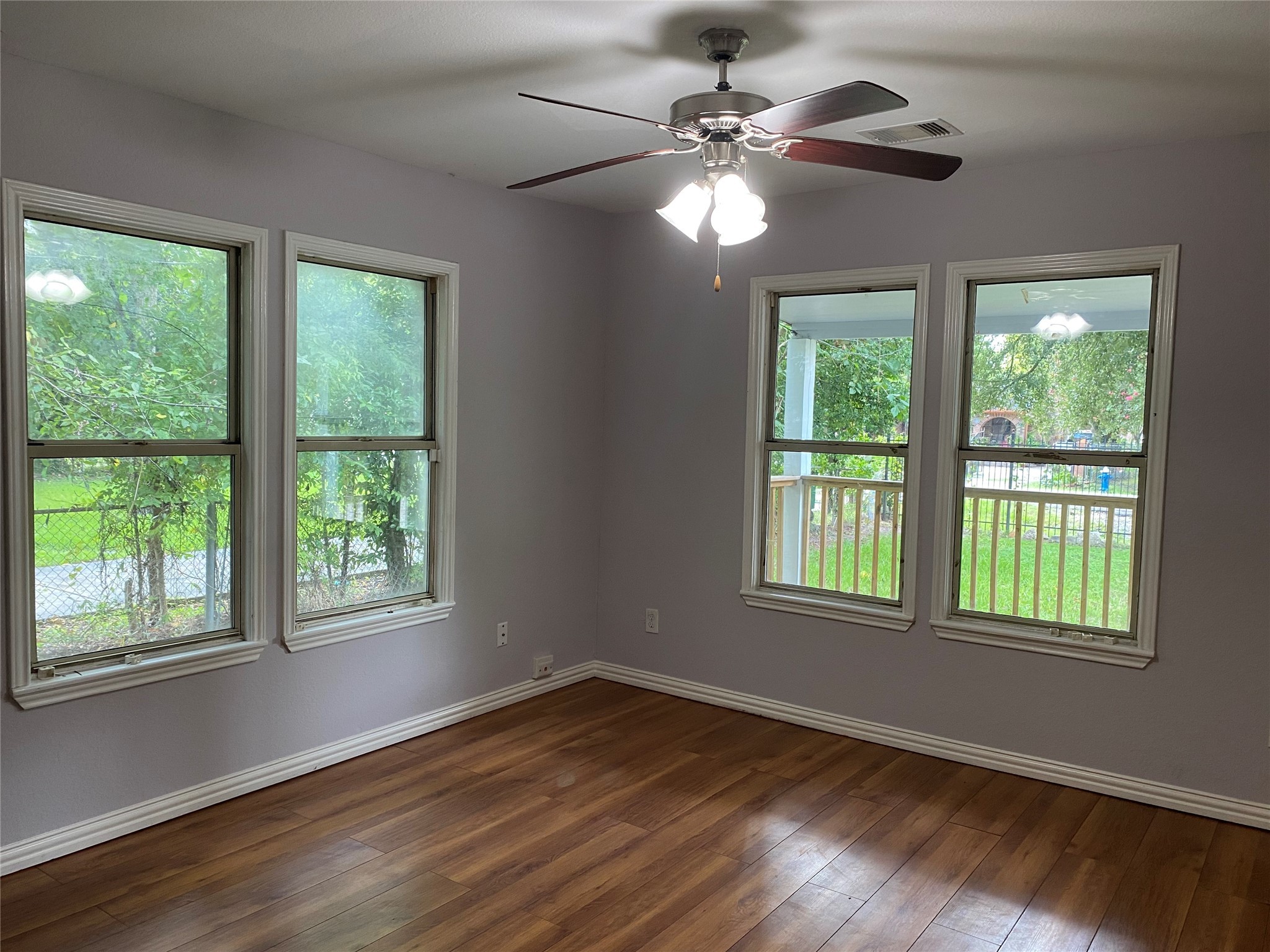 819 Eubanks Street Houston, TX 77022 - Photo 10 of 15 a view of an empty room with wooden floor and a window