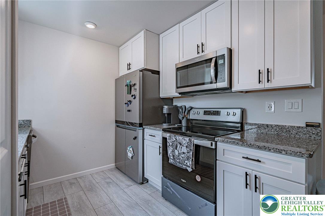 25 North 8th Street Emmaus, PA 18049 - Photo 11 of 51 A well-appointed kitchen features stainless steel appliances and abundant white cabinetry.