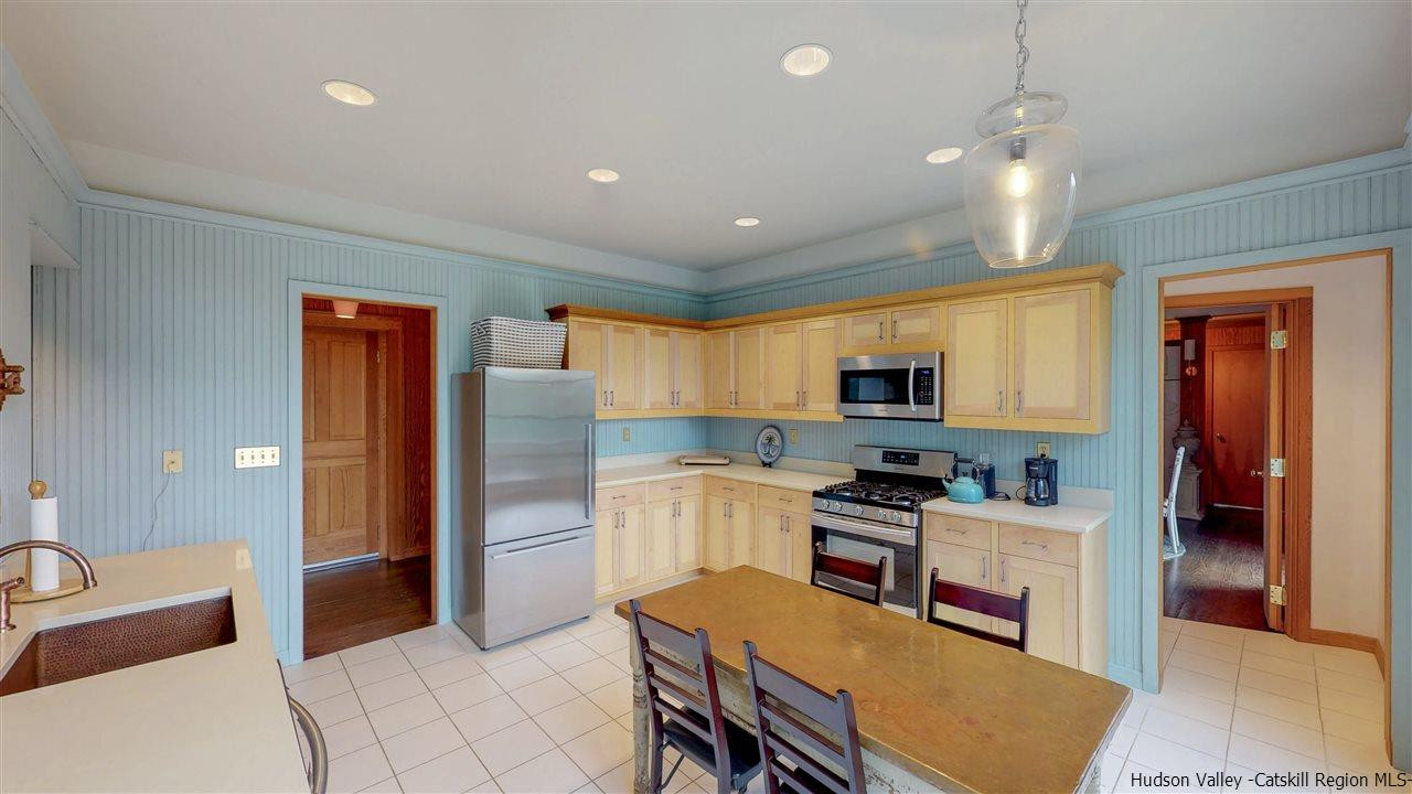 38 Frost Valley Road Claryville, NY 12725 - Photo 11 of 30 a kitchen with stainless steel appliances granite countertop a refrigerator sink and cabinets