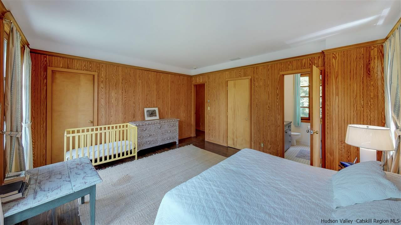 38 Frost Valley Road Claryville, NY 12725 - Photo 12 of 30 a bedroom with a bed and wooden floor