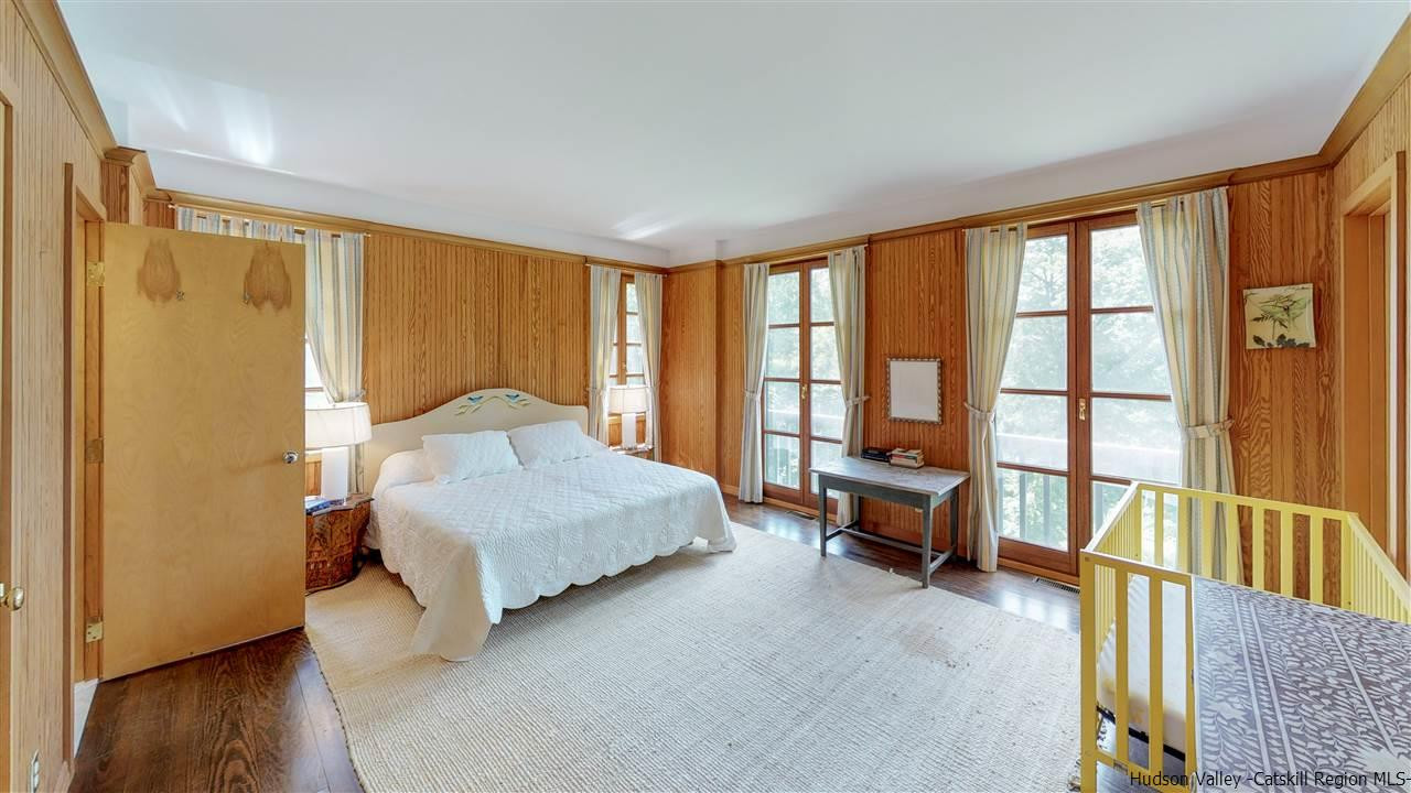 38 Frost Valley Road Claryville, NY 12725 - Photo 13 of 30 a bedroom with a bed and wooden floor