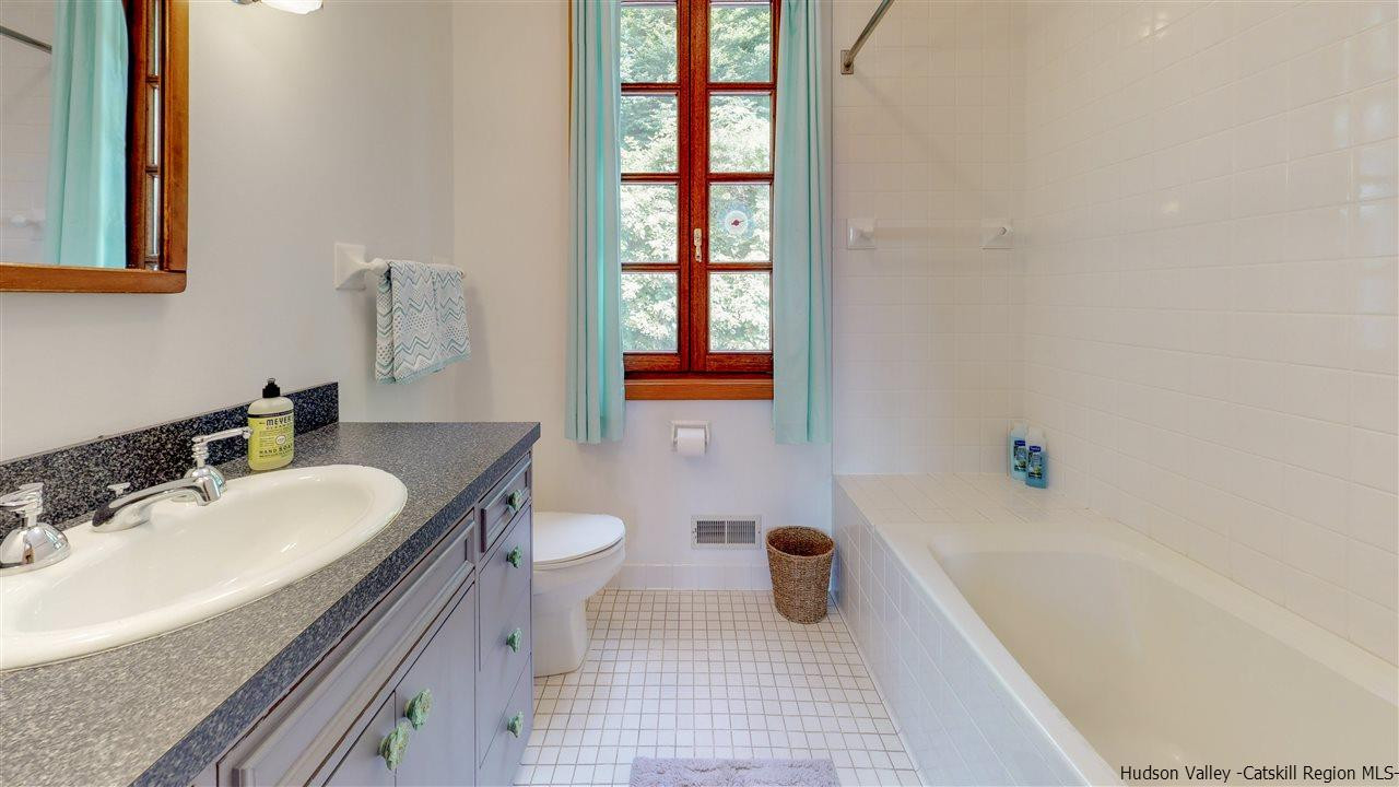 38 Frost Valley Road Claryville, NY 12725 - Photo 14 of 30 a bathroom with a sink a bathtub and a toilet