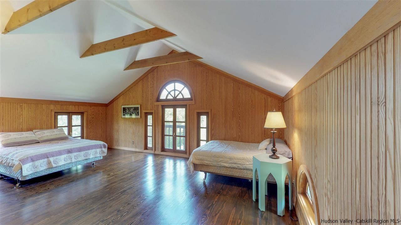 38 Frost Valley Road Claryville, NY 12725 - Photo 19 of 30 a bedroom with a bed next to a large window