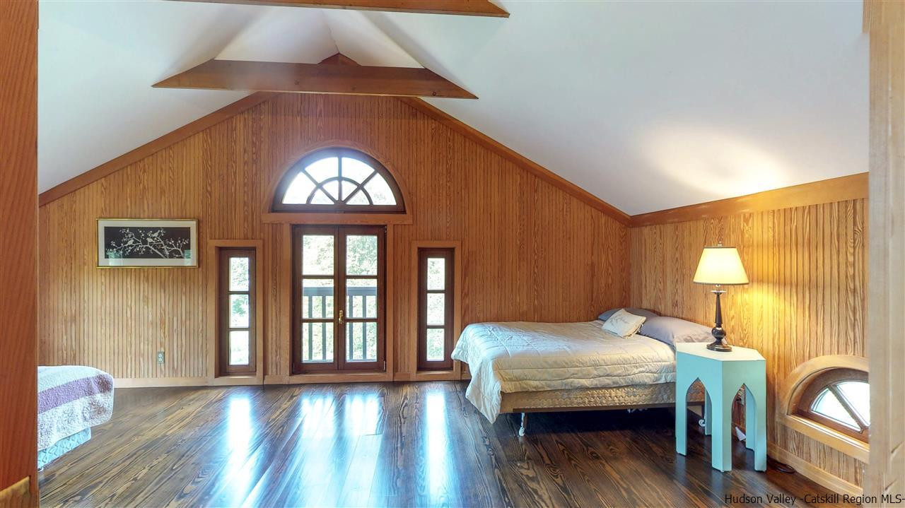 38 Frost Valley Road Claryville, NY 12725 - Photo 20 of 30 a bedroom with a bed and wooden floor