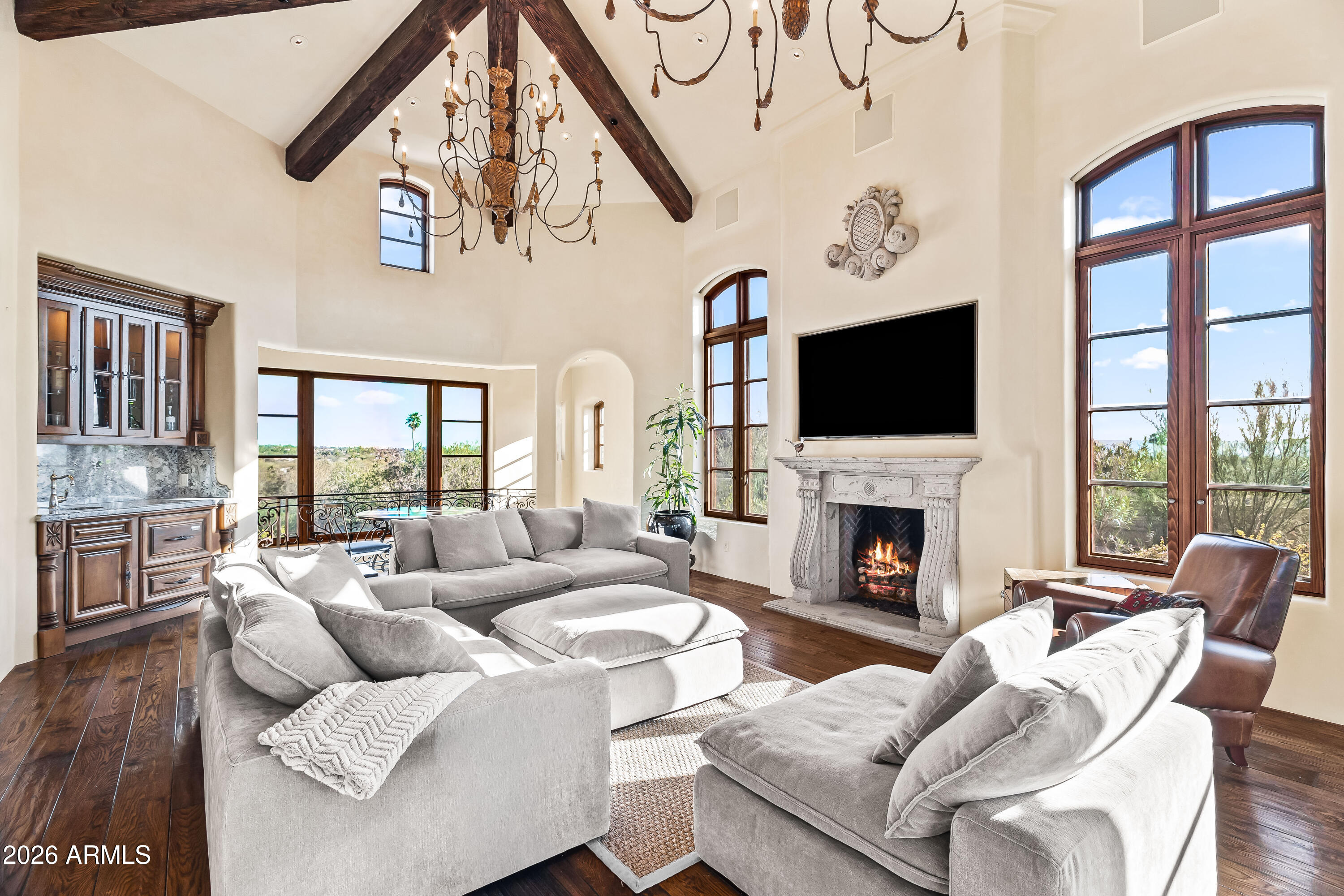 3900 East Bethany Home Road Paradise Valley, AZ 85253 - Photo 11 of 51 a living room with furniture a fireplace and a floor to ceiling window