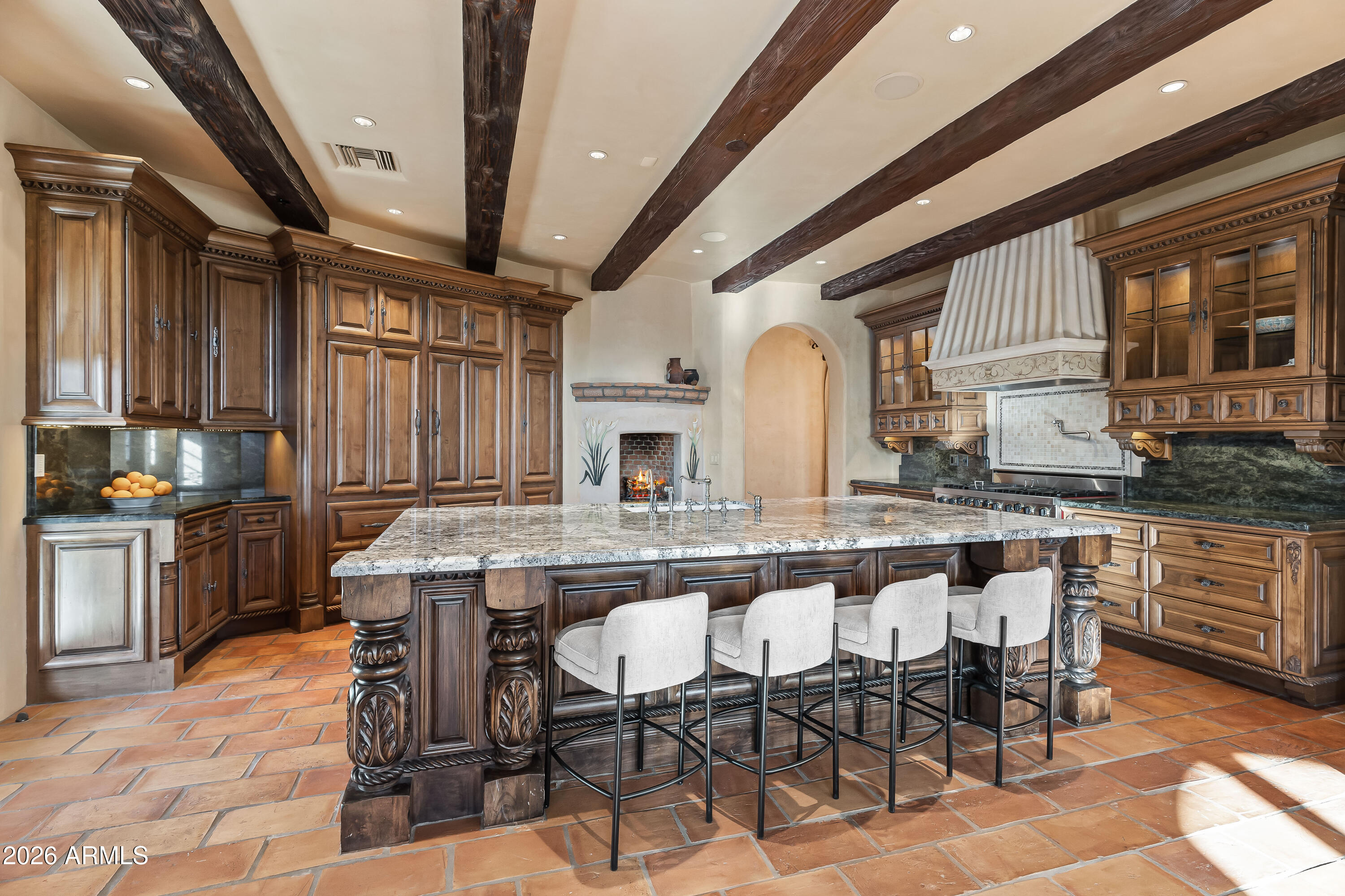 3900 East Bethany Home Road Paradise Valley, AZ 85253 - Photo 13 of 51 a kitchen with stainless steel appliances granite countertop a table chairs sink and cabinets