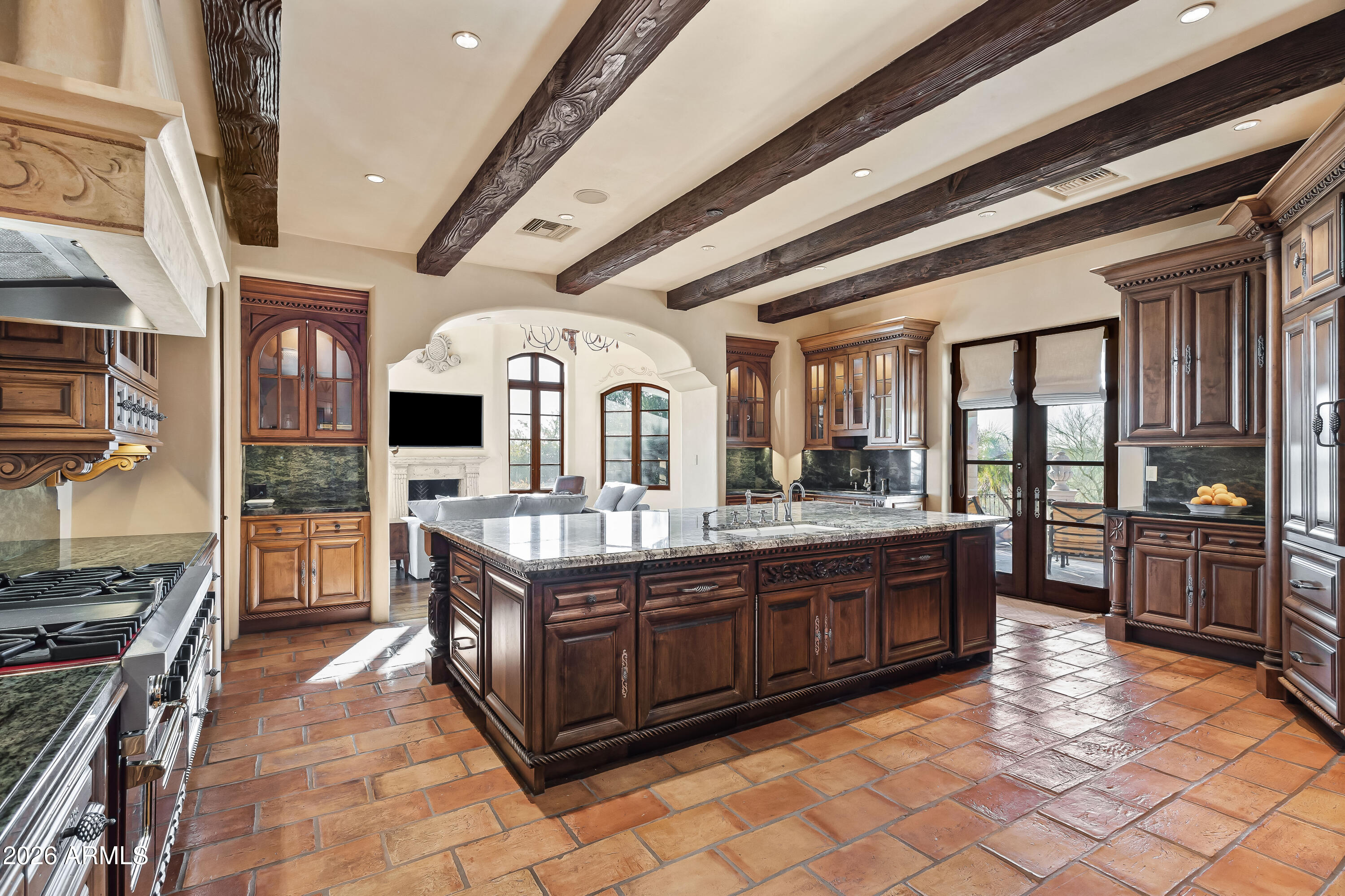 3900 East Bethany Home Road Paradise Valley, AZ 85253 - Photo 15 of 51 a large kitchen with stainless steel appliances granite countertop a large stove top oven and cabinets